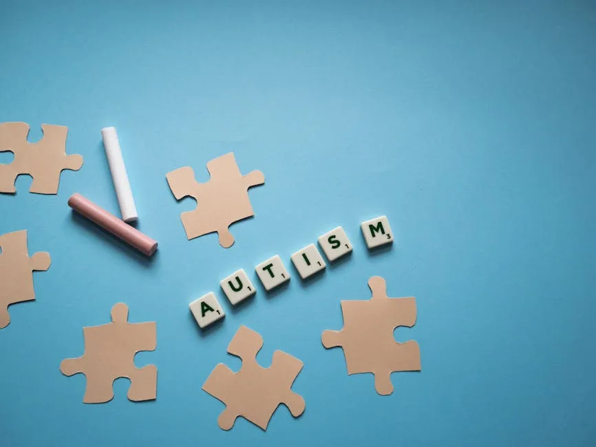 Puzzle pieces with 'autism' text on blue background, promoting autism awareness.